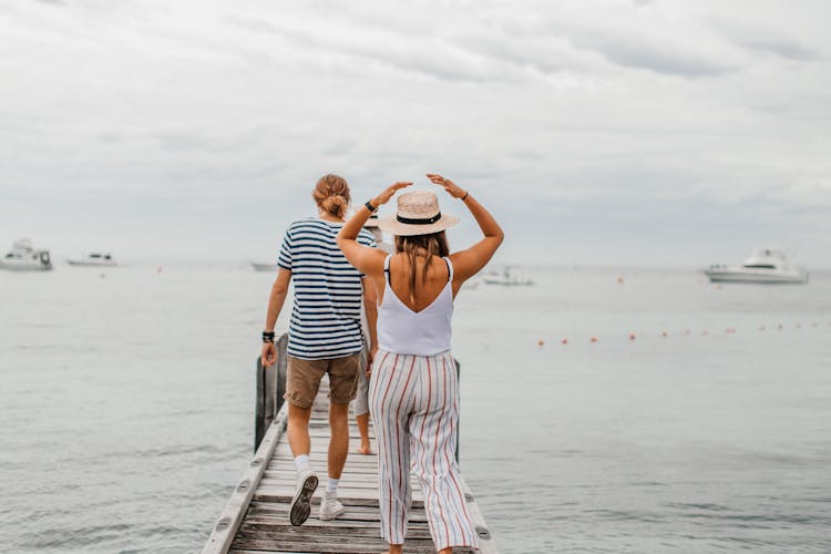 People Walking On A Wooden Deck