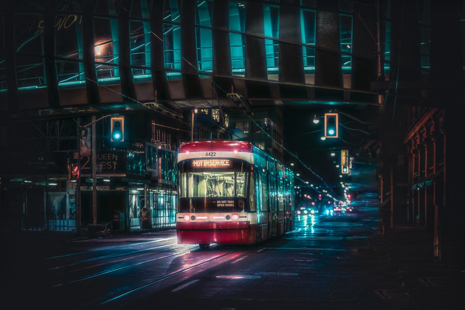 A vibrant streetcar navigates through Toronto at night, highlighting the city's dynamic transportation system.