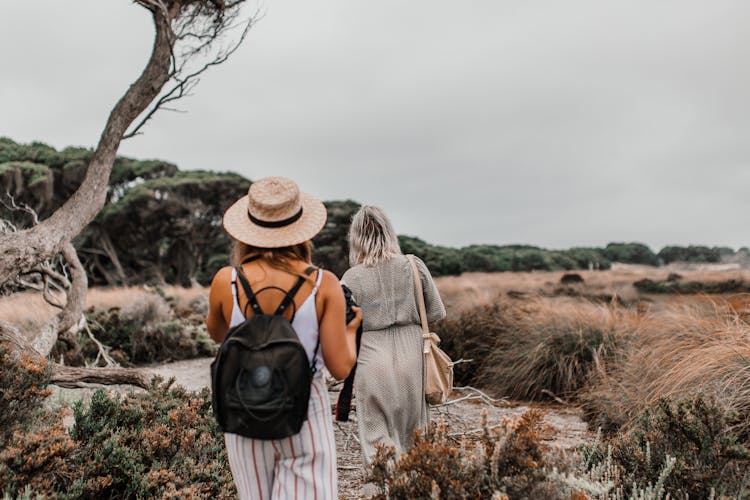 Women Roaming In Grassland