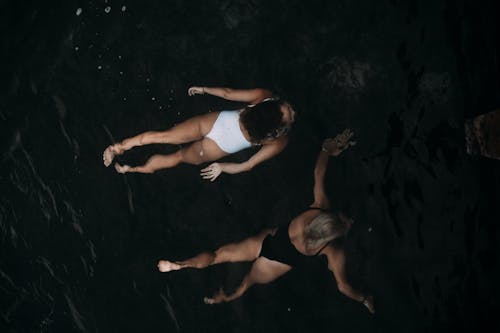 Free Women Swimming in Deep Waters Stock Photo
