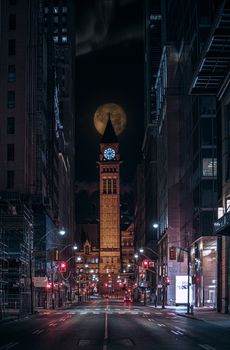 Stunning night view of Toronto's Old City Hall with illuminated clock tower and streetlights.