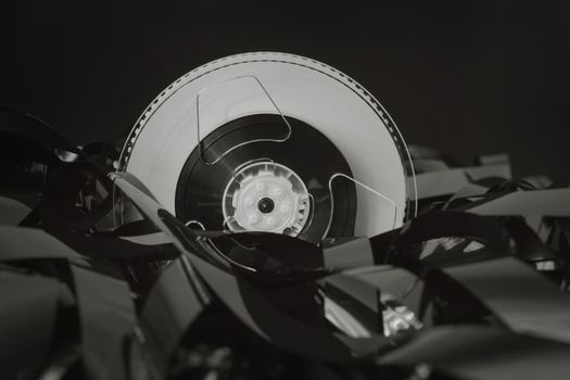 Close-up of a vintage cassette tape against a black background, showcasing retro technology.