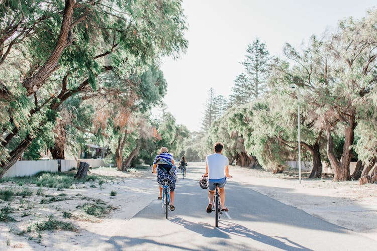 People Riding Bicycles On The Road