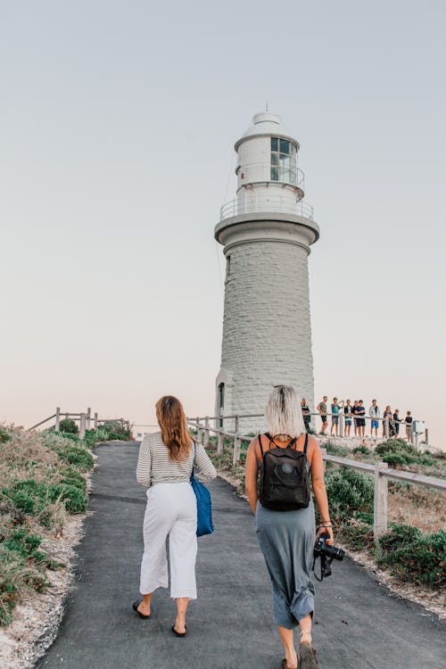 Women Walking Near the Lighthouse Tower