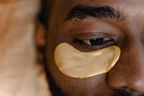 Free A Person with a Gold Under Eye Patch Stock Photo