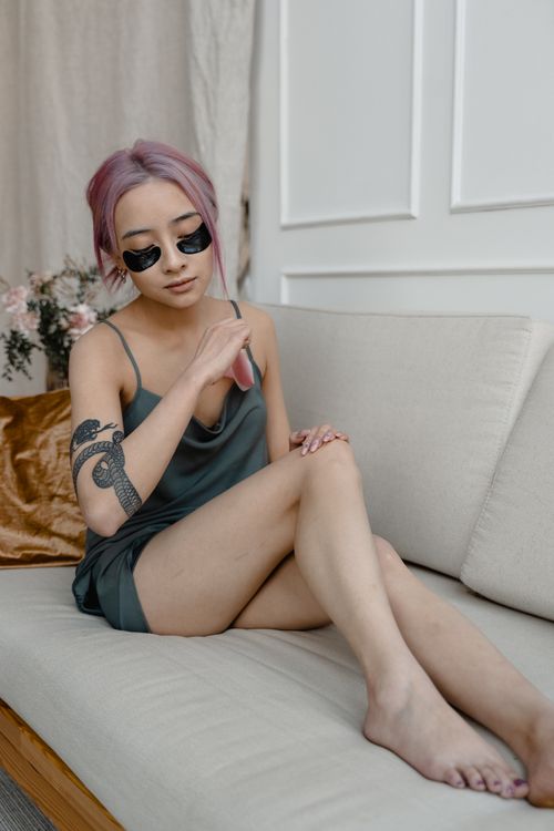 Free A relaxed Asian woman with under-eye patches, focusing on beauty and self-care. Stock Photo