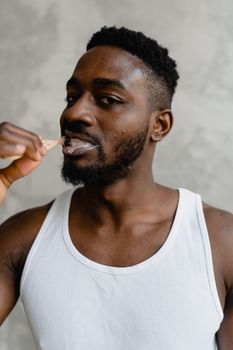 Close-up of a young man brushing his teeth, emphasizing oral hygiene and daily care routine.