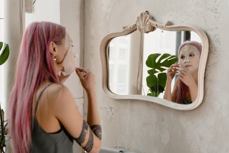 A Woman Peeling Her Face Mask