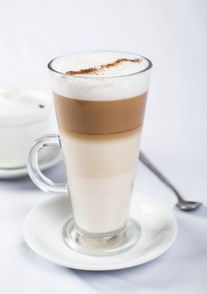 Layered latte macchiato in a tall glass mug — photo by Joao Socola on Pexels