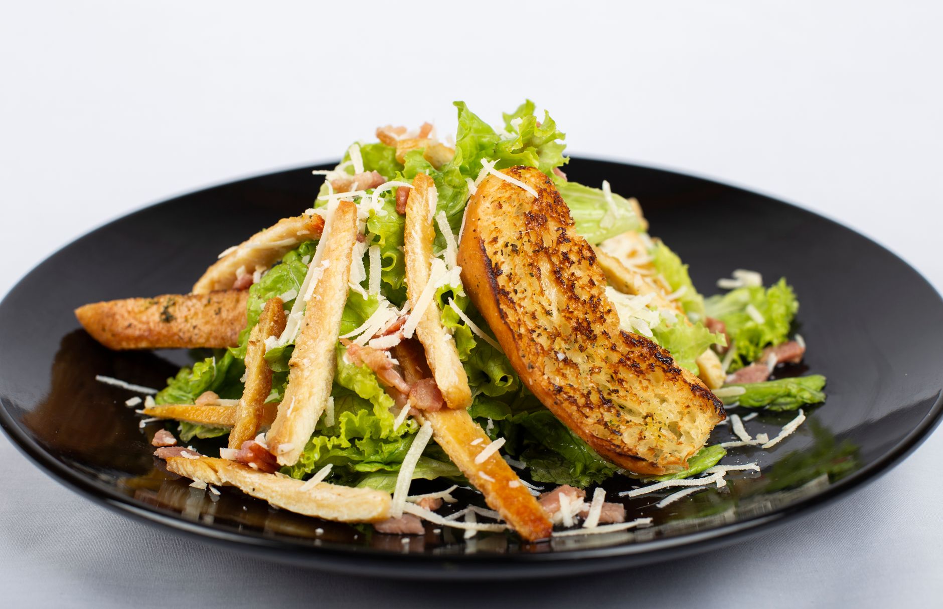Greek salad with croutons on a wooden table