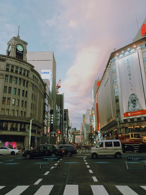 Free Vibrant urban scene in Chuo City, Tokyo with traffic and iconic buildings at dusk. Stock Photo
