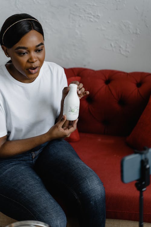 A Woman Holding a Cosmetic Product