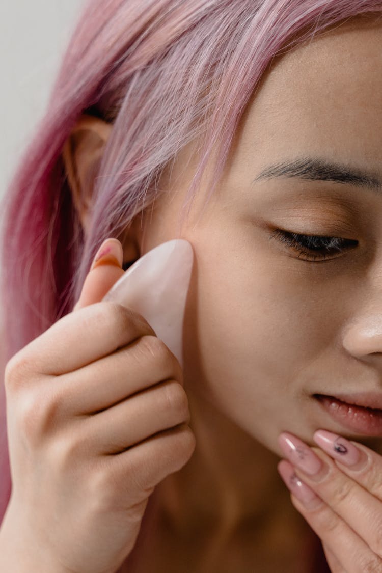 Close-Up Shot Of A Woman Peeling Her Face Mask