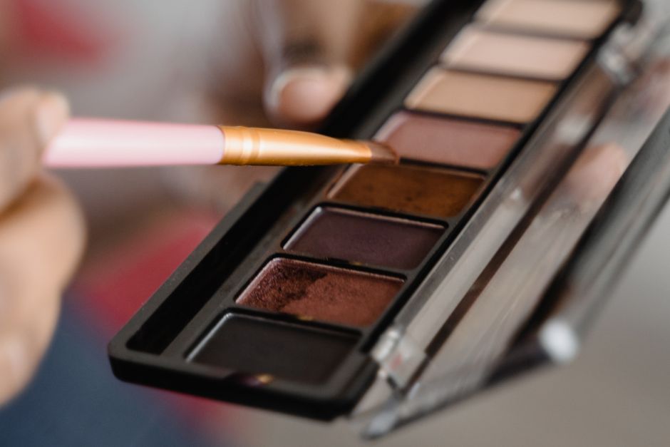 A detailed close-up of an eyeshadow palette with a makeup brush in use. - Top 5 Lighted Vanity Makeup Mirrors on Amazon Under $40