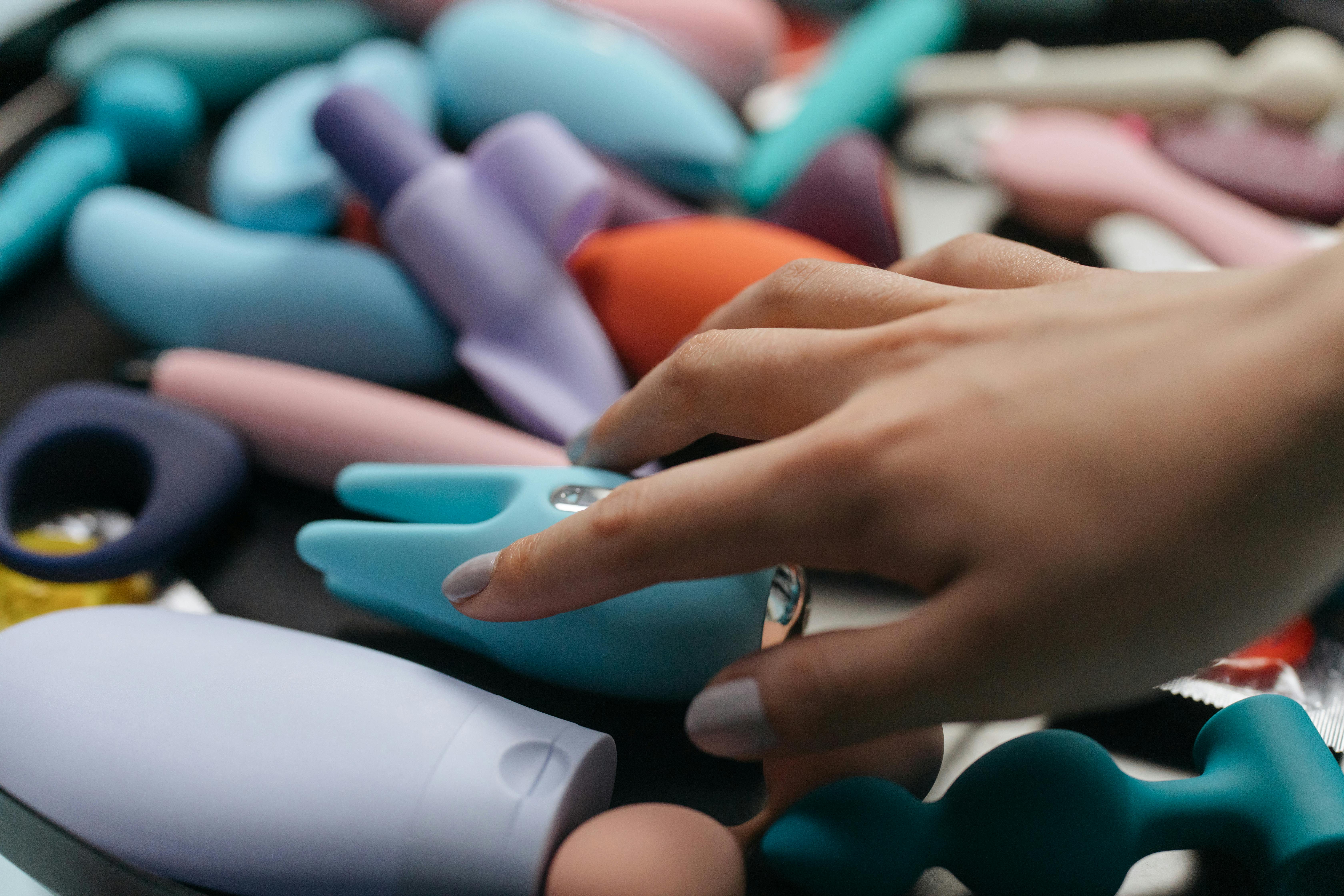 woman hand on colorful dolls