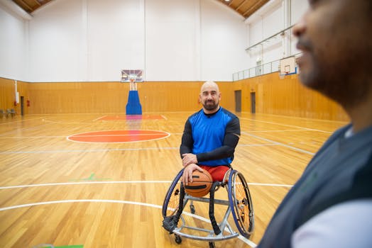 Disabled athlete practicing wheelchair basketball in an indoor court, promoting sportsmanship and inclusion.