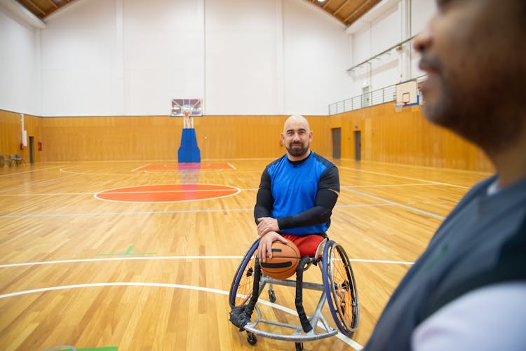 A Wheel-chaired Man Playing Basketball