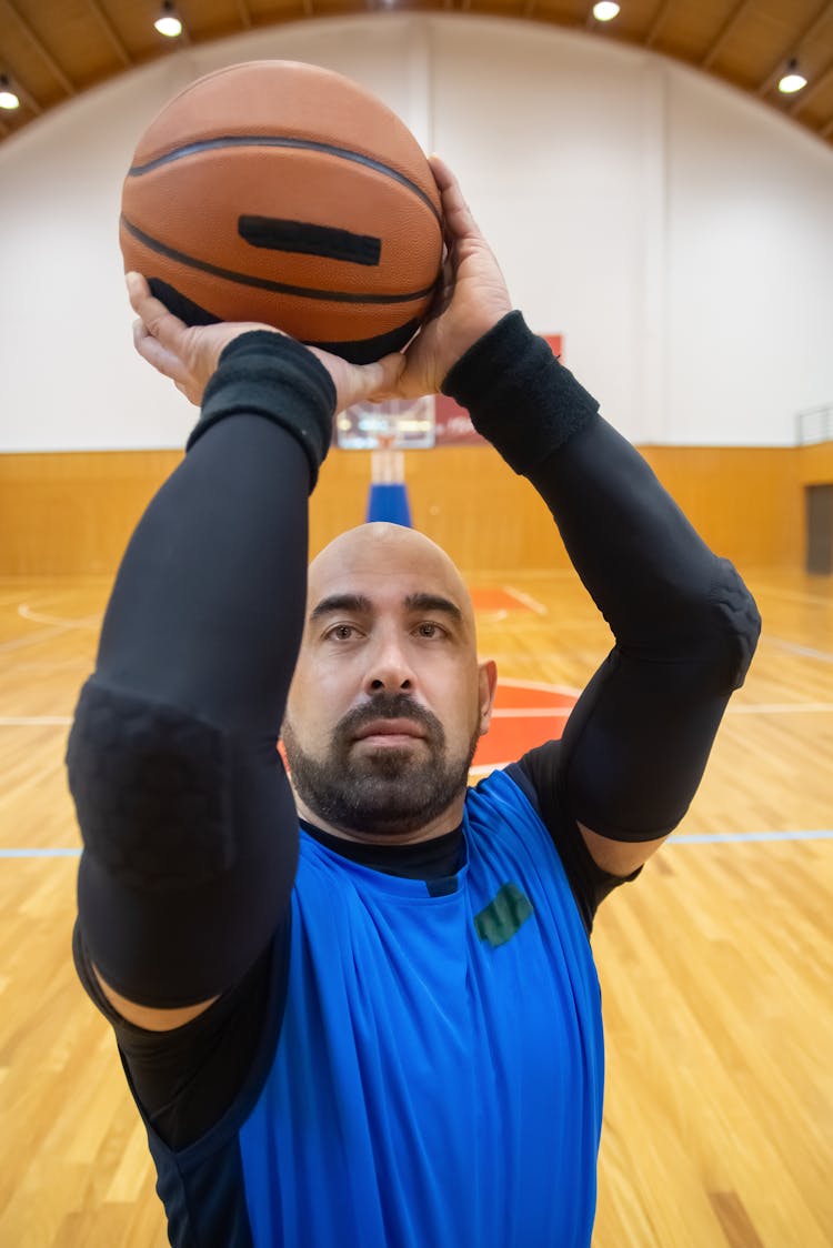 A Man Holding Shooting The Basketball