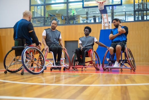Wheelchair basketball players strategize during a game, showcasing inclusivity and sportsmanship.