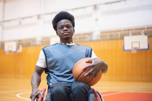 Inspirational young athlete on a basketball court holding a ball with determination.