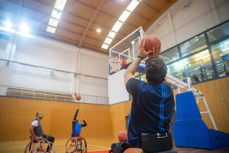 Man In Wheelchair Shooting The Ball