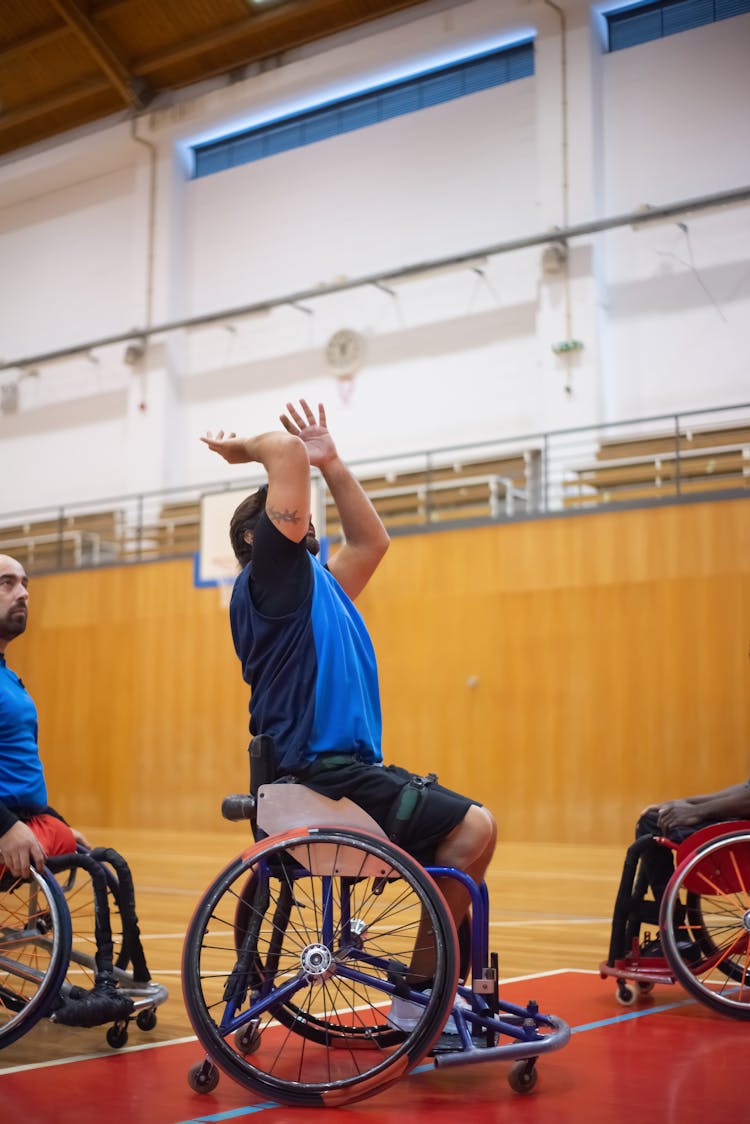 Men On Wheelchairs Playing Basketball At Sports Hall