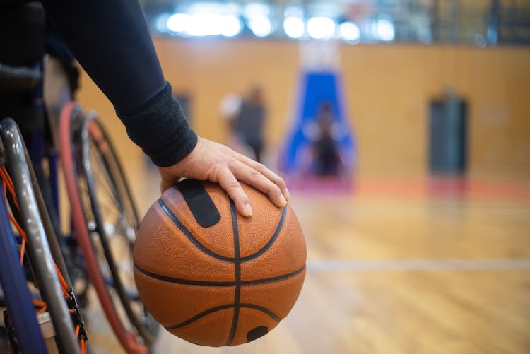 A Person Holding A Basketball