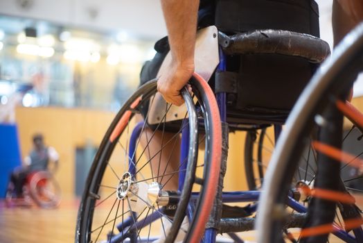 Dynamic close-up of a basketball player in a wheelchair during a game, focusing on athleticism.