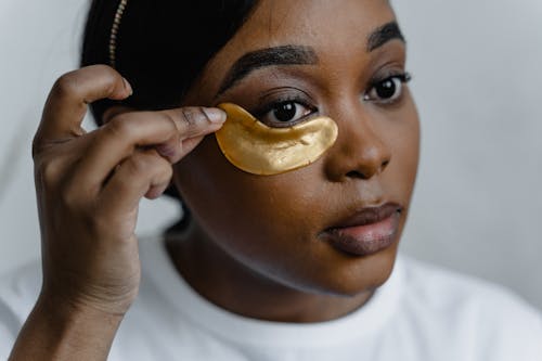 Woman Applying Eye Patch