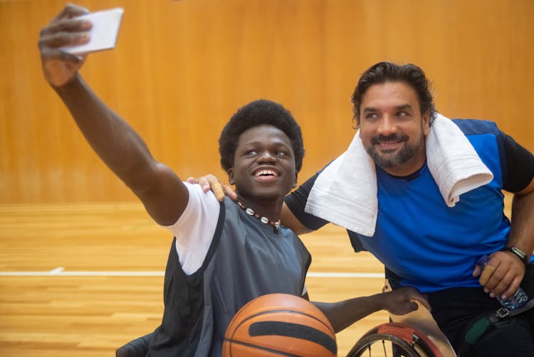 Two Men Taking Selfie On A Basketball Court