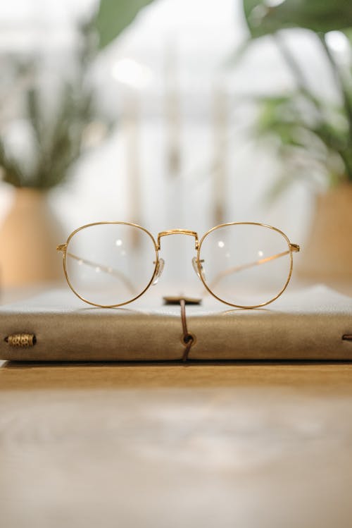 Gold Framed Eyeglasses on the Table