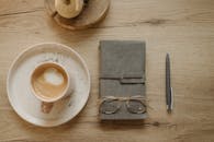 Gold Framed Eyeglasses on Top of the Notebook