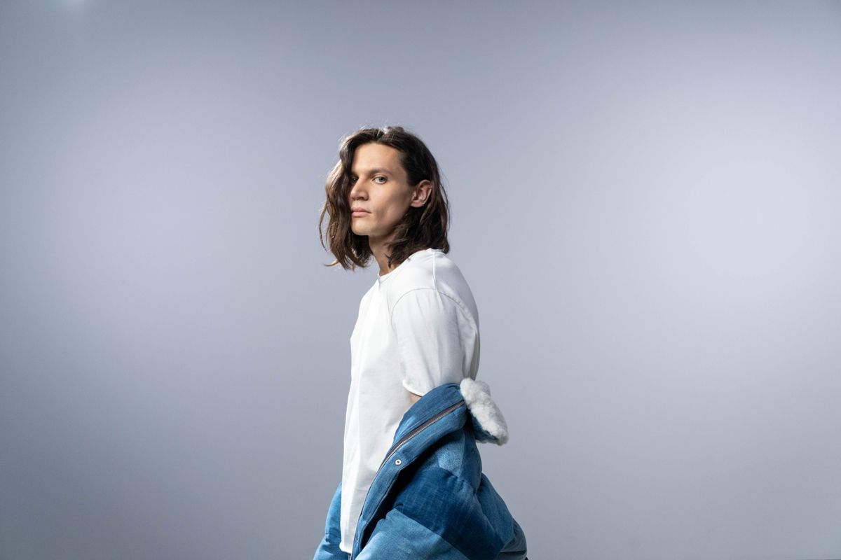 Striped pants styled with a contrasting texture top showing three-dimensionality in the outfit