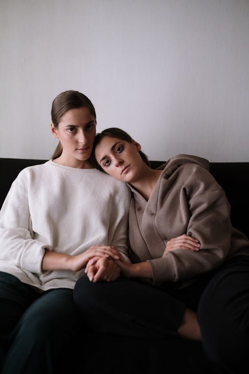 Woman in White Sweater Sitting Beside Man in Gray Sweater