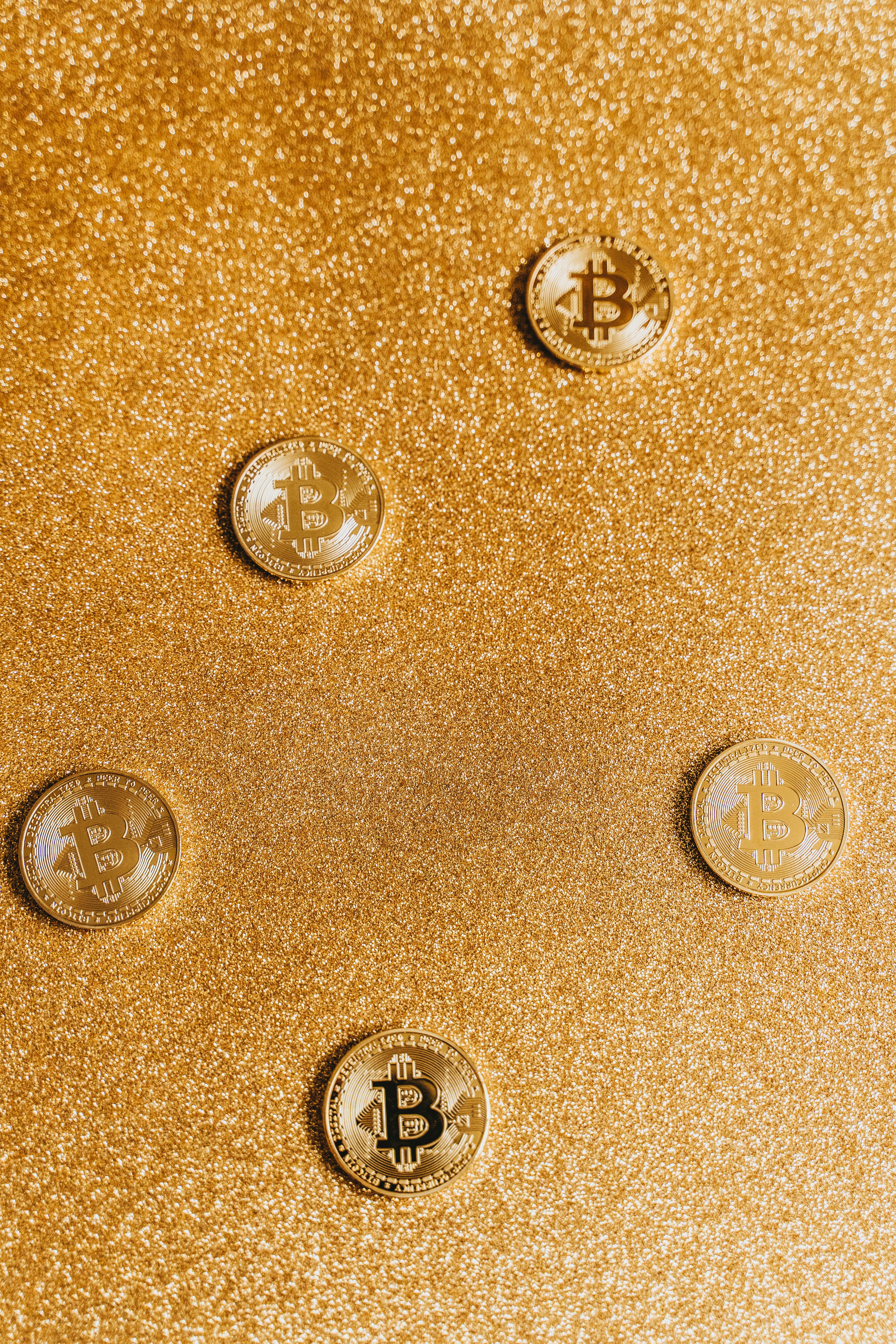 gold round coins with a glittery background