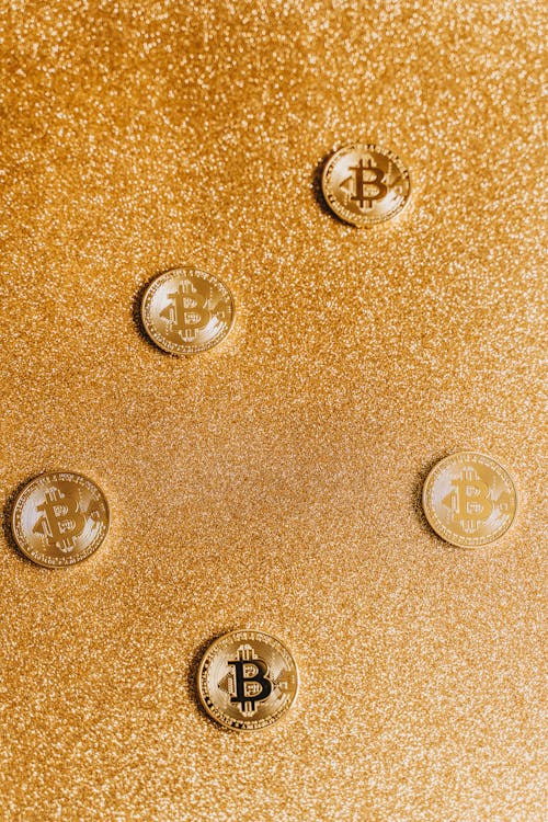 Gold Round Coins with a Glittery Background