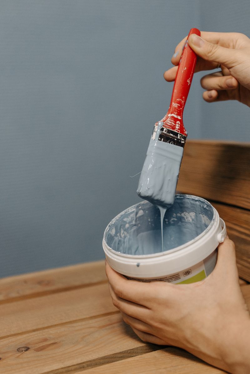 Paintbrush dipped in vivid blue paint