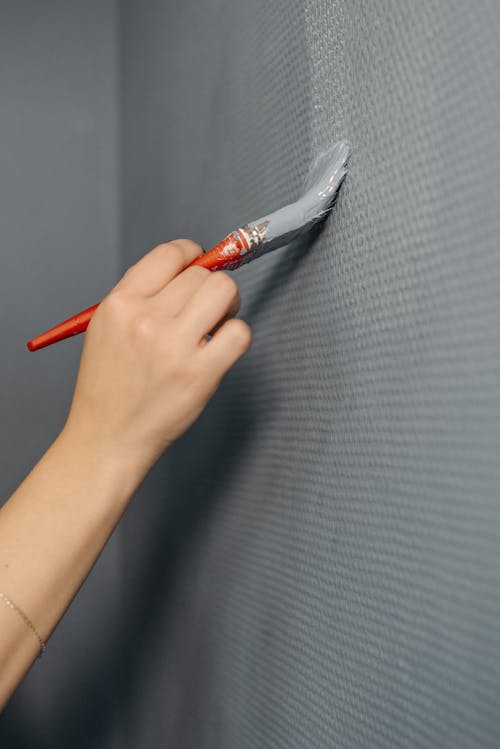 A Person Painting a Wall