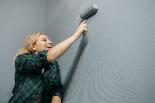 Woman Painting Wall with a Paint Roller