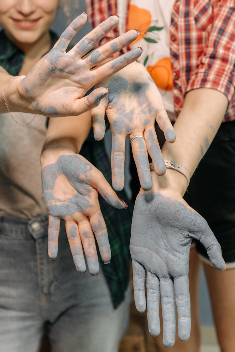 People Hands Covered With Gray Paint