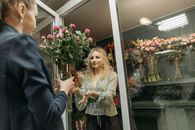 Woman Holding a Vase with Flowers