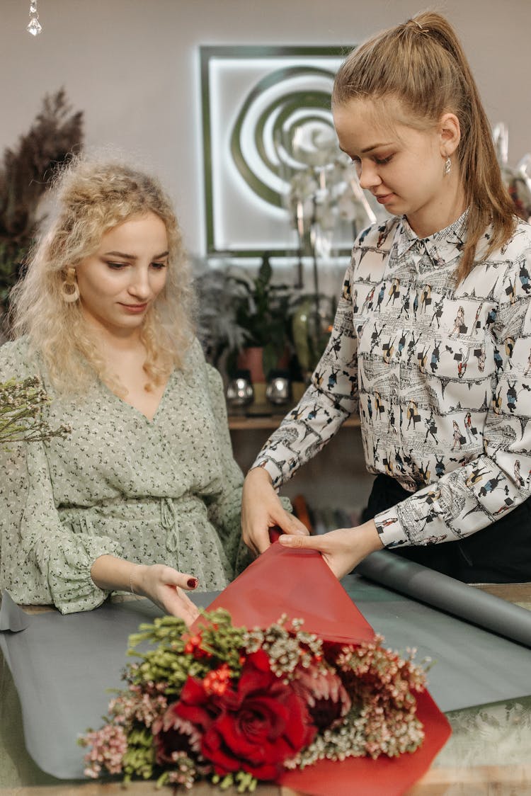 Women Arranging A Flower Bouquet