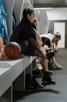 Teenage girls in a locker room getting ready for a basketball game.