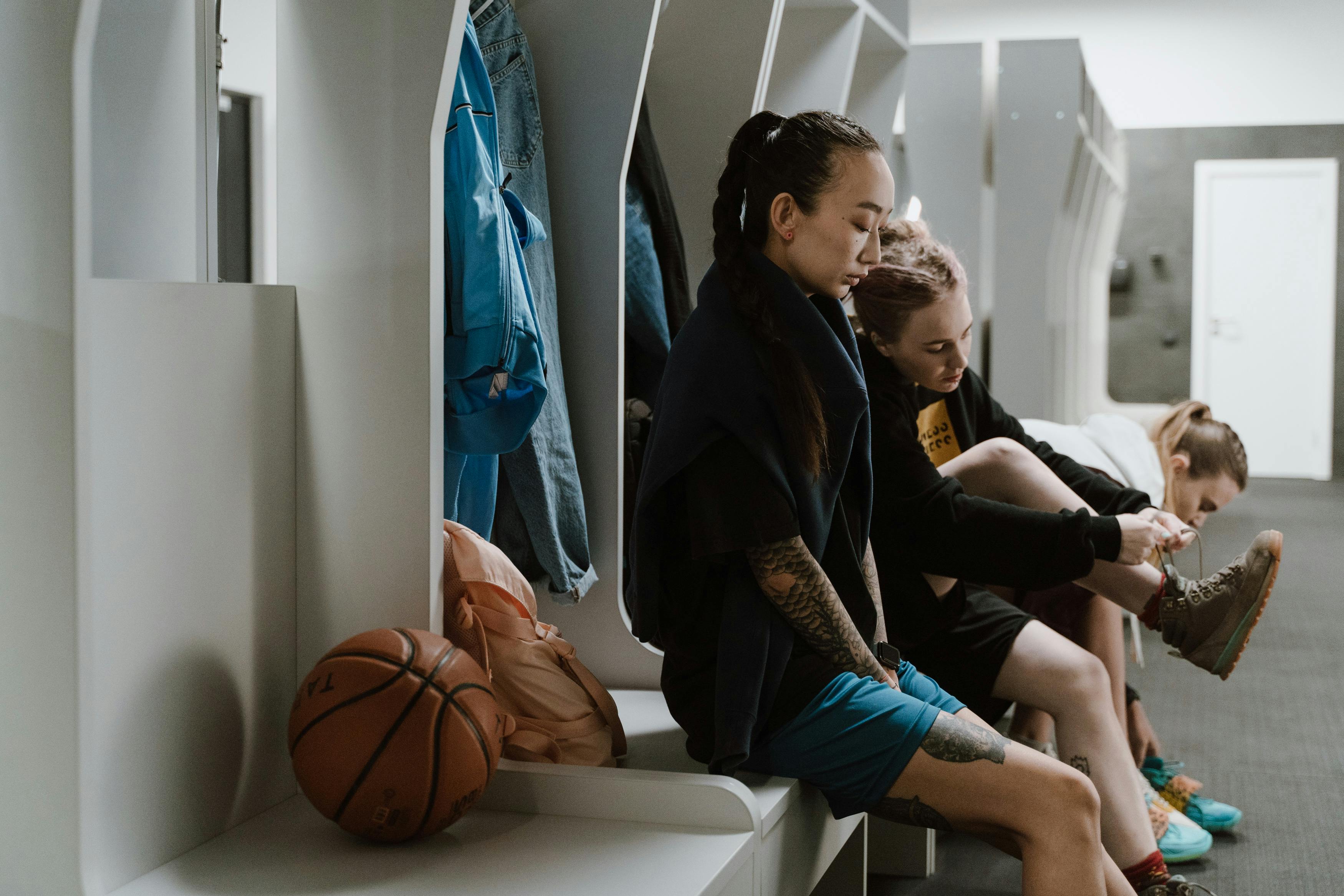 women sitting at locker room