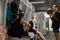 Girls with a Basketball Discussing in a Changing Room
