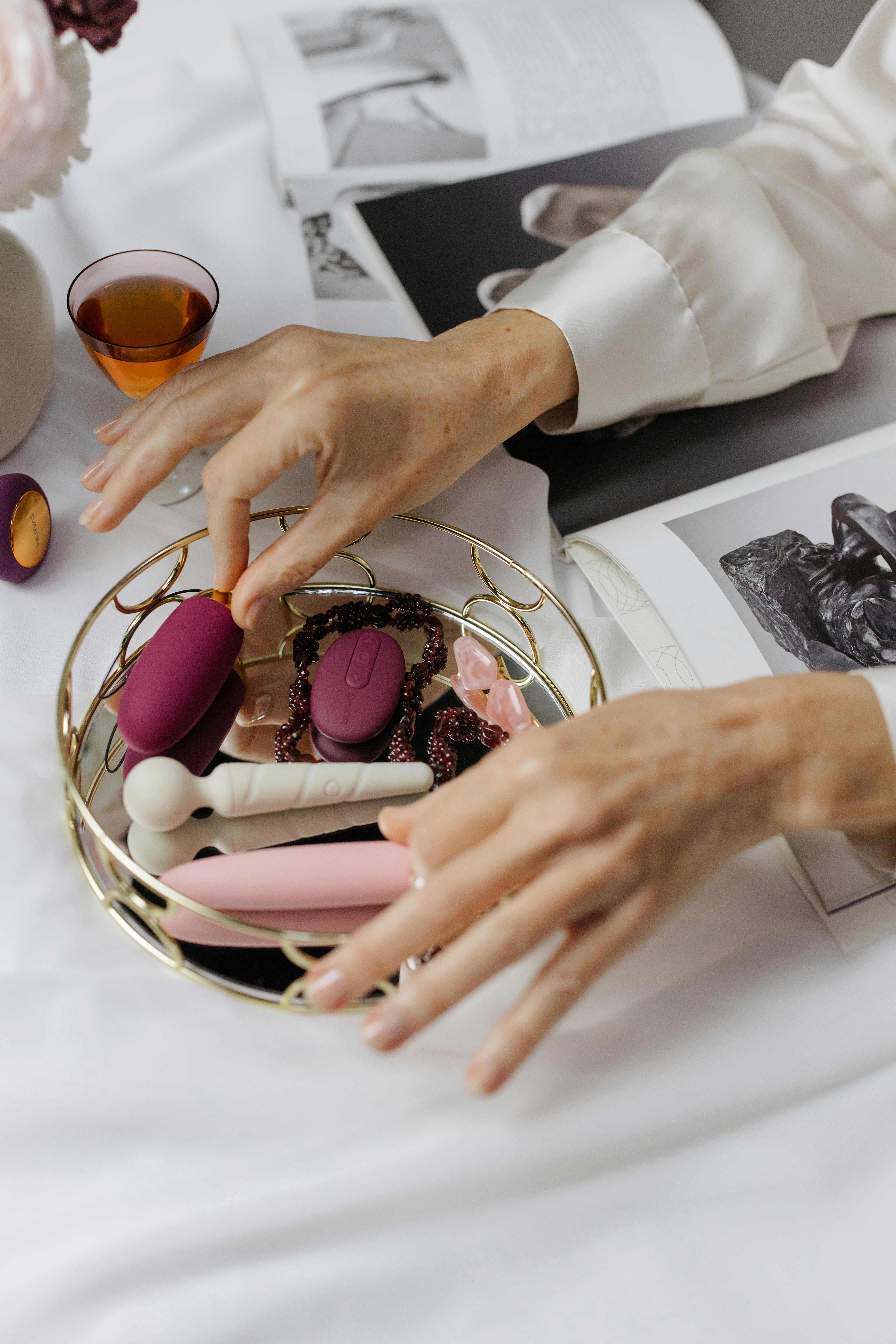 close up photo of person s hands in a small golden tray