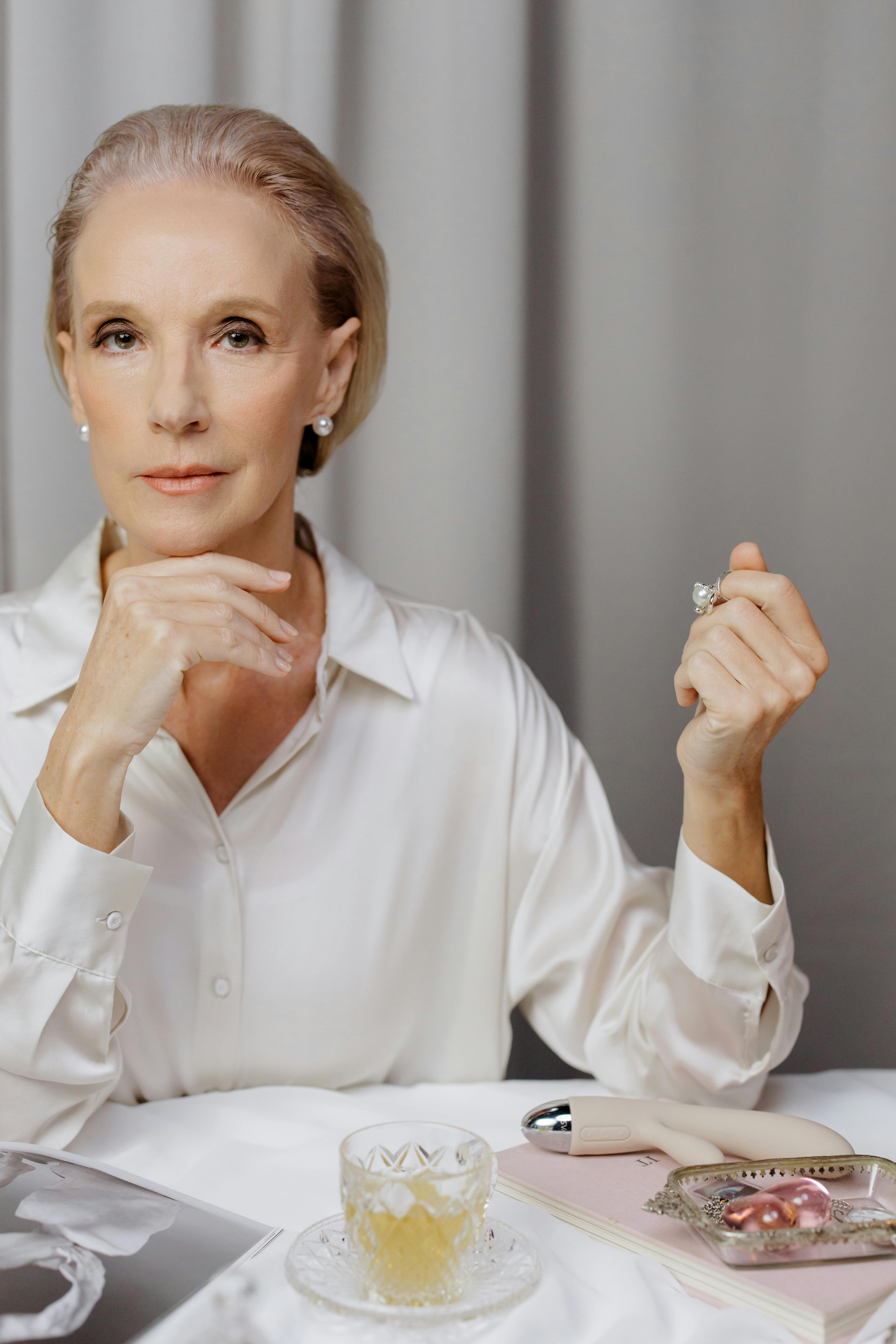 woman sitting at table with dildo on it