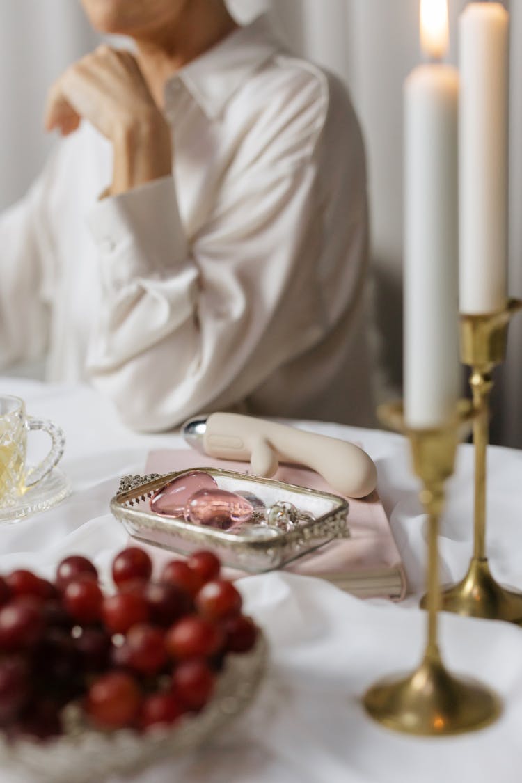 White Candles And Grapes On The Table