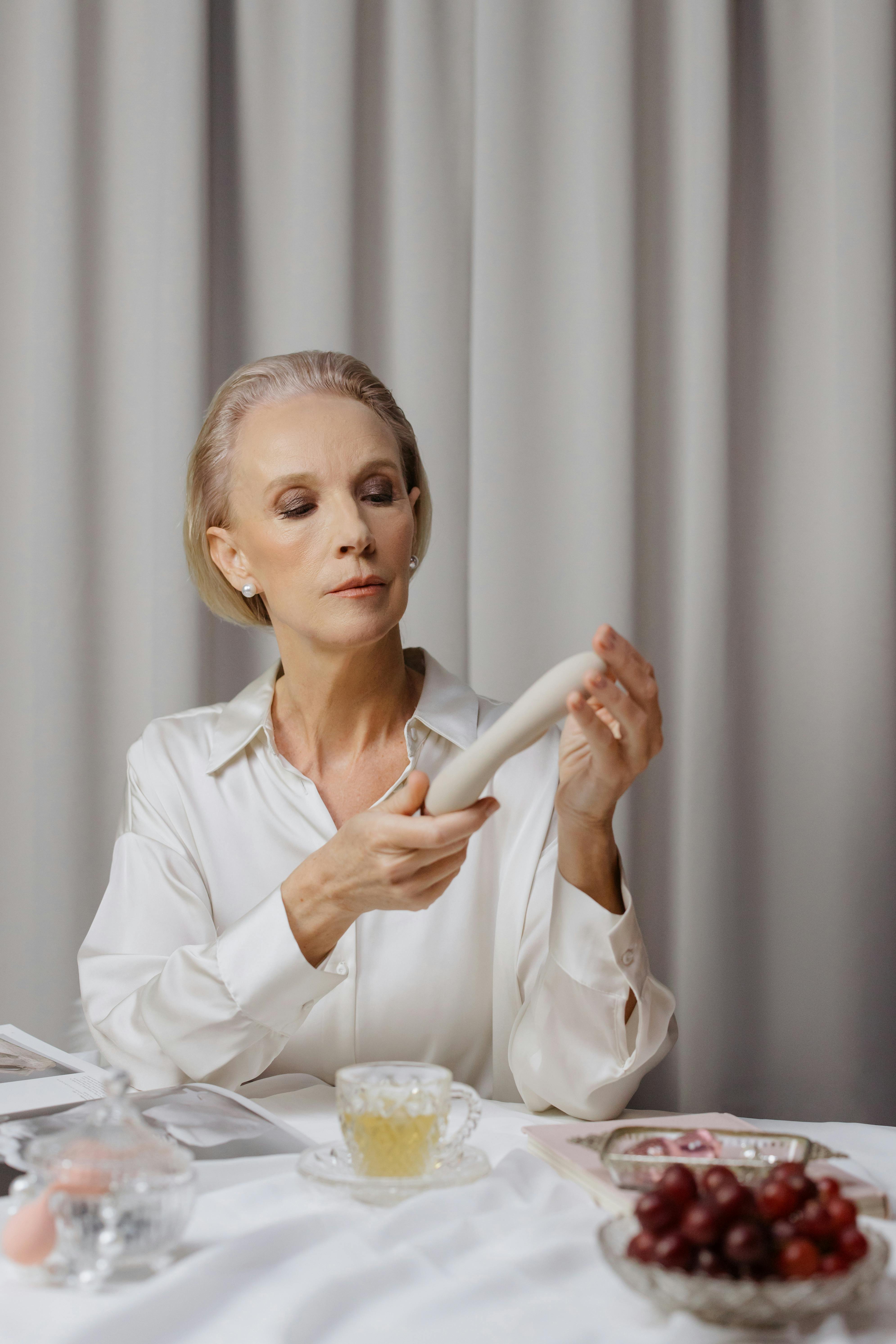 elderly woman holding a vibrator