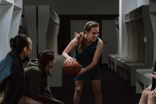 A dynamic moment of basketball players sharing team spirit in a locker room.